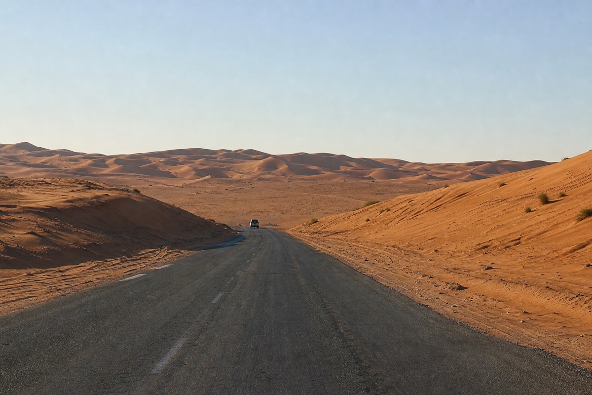 An open desert highway running southeast from Muscat, part of the Muscat to Wahiba Sands drive