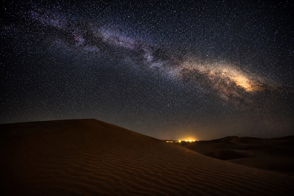 The Milky Way glowing over the dunes, a night view for those deciding where to stay near Wahiba Sands