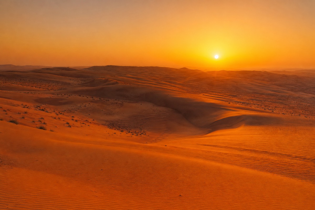 Sunset over the dunes of Wahiba Sands, golden light worth packing for Wahiba Sands layers