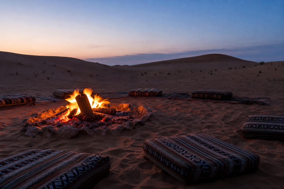 A desert camp lit up after dark in Wahiba Sands