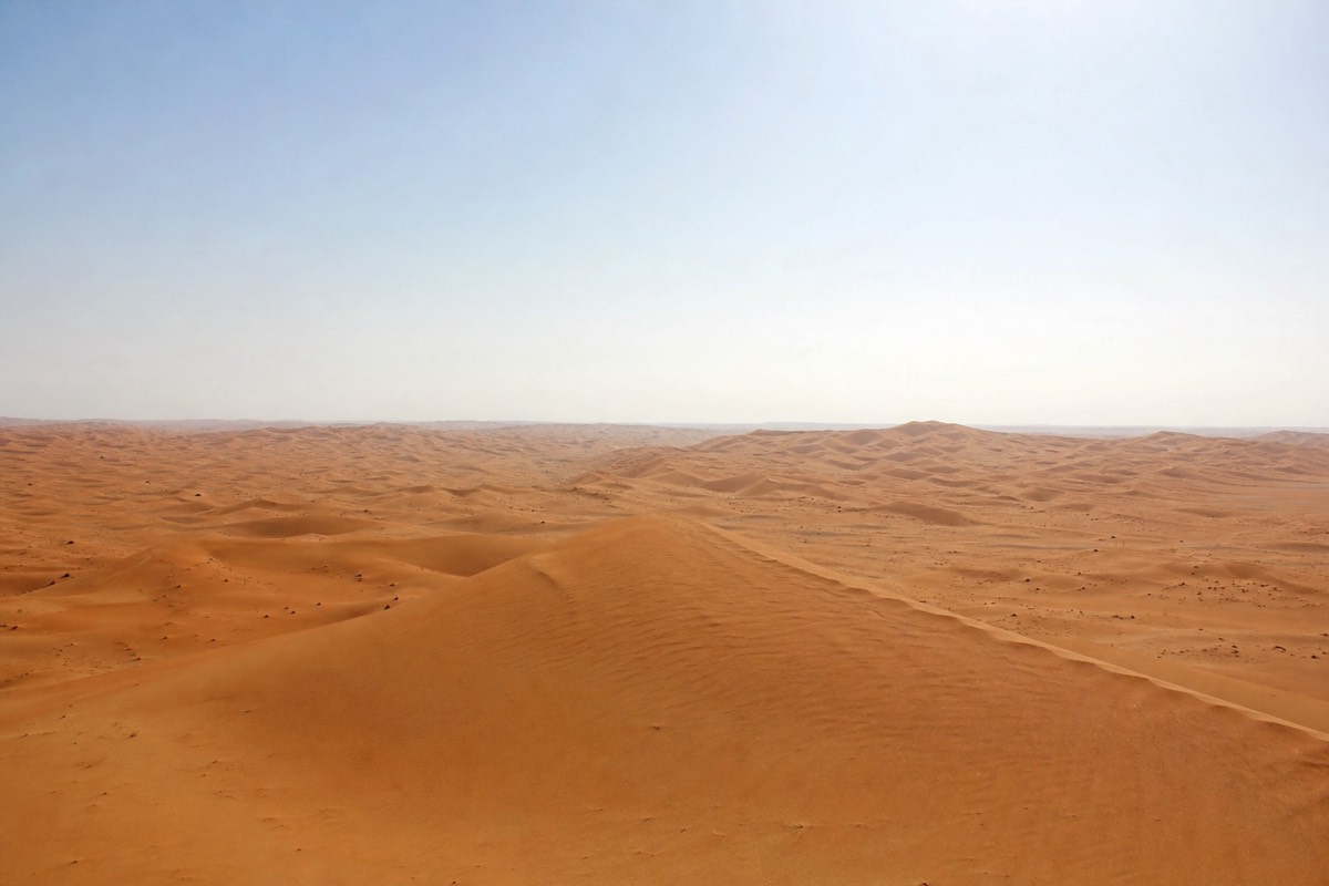Getting to Wahiba Sands from Muscat ends among vast golden dunes rising above the desert floor